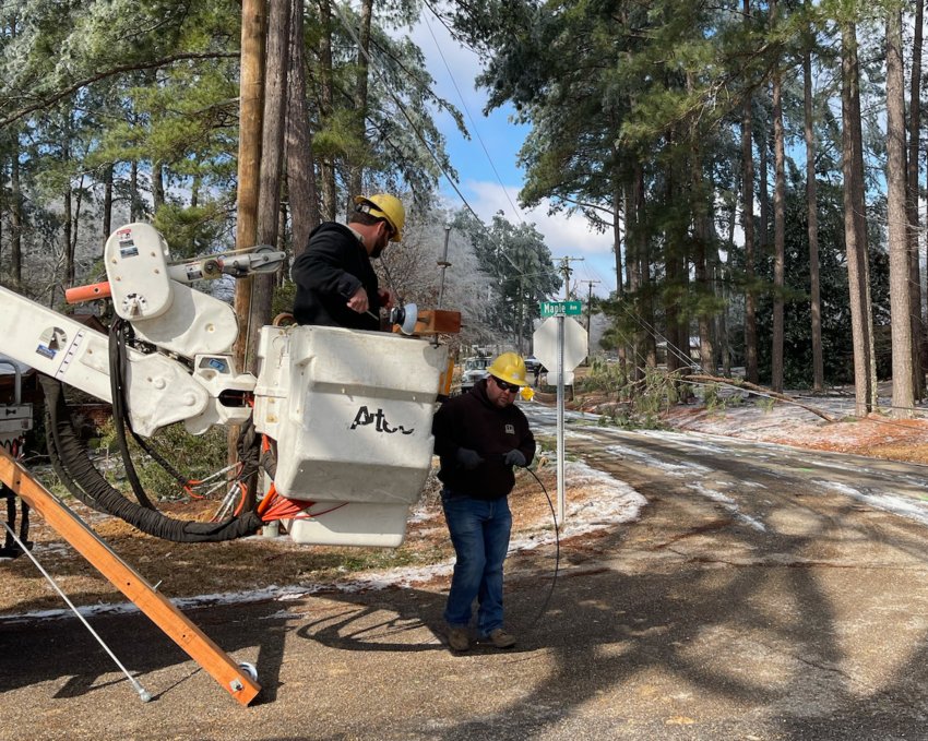 A crew works to restore power on Maple Avenue in Woodland Hills following winter storms that hit Mississippi last week on Monday and Wednesday. Ice accumulation on power lines and trees caused severe power outages throughout most of Neshoba County.